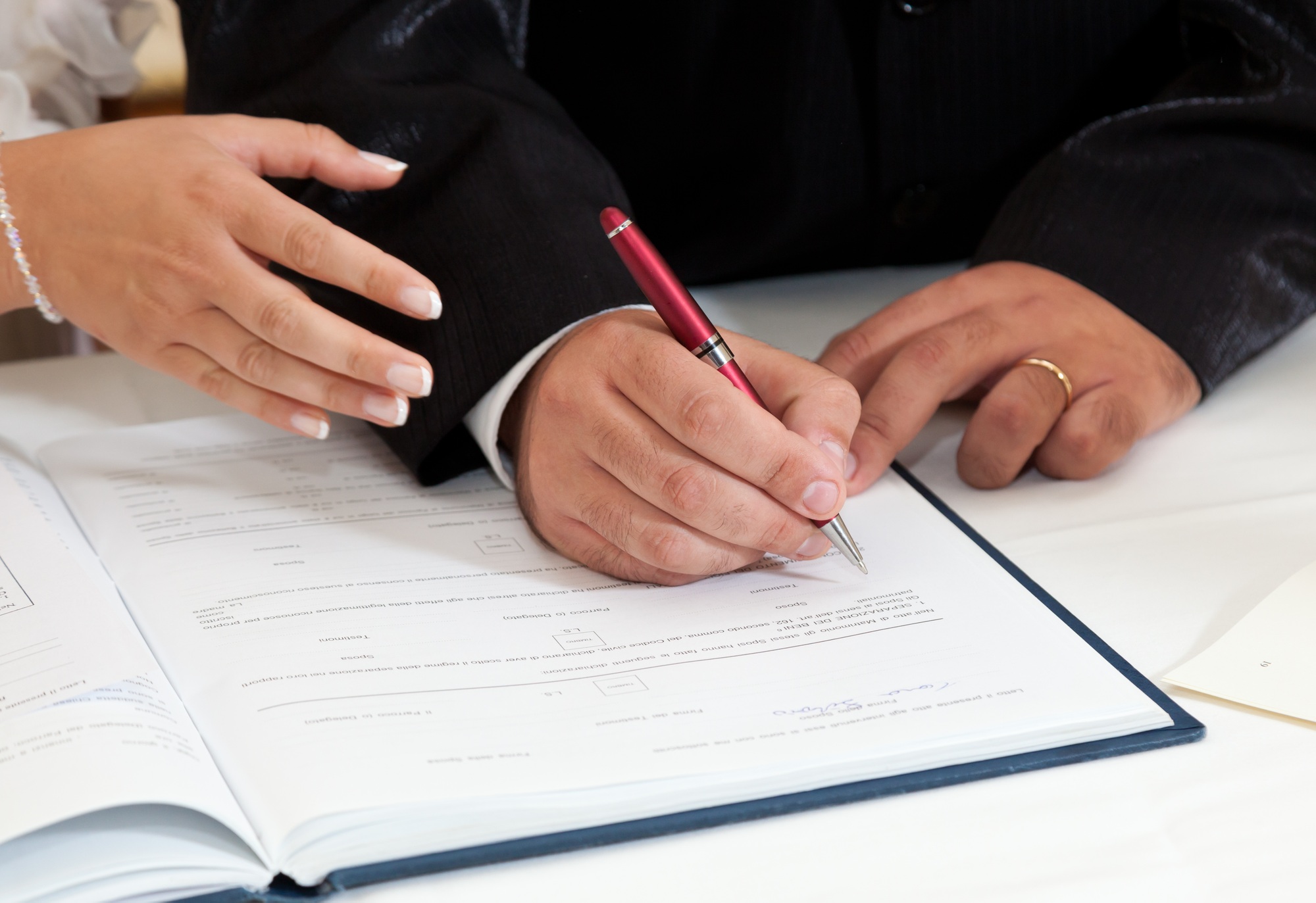 Bride and Groom Signing Marriage Certificate