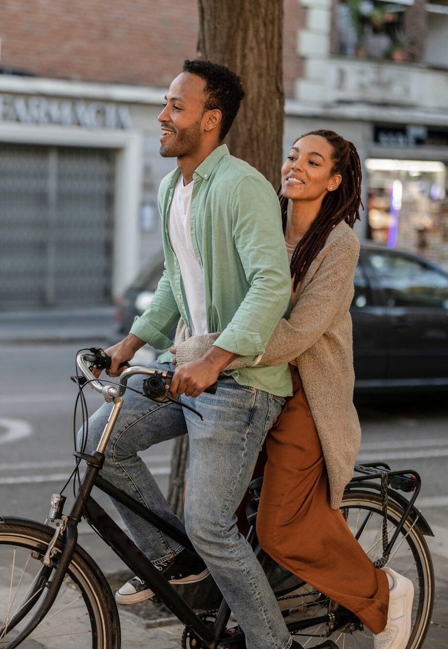 happy tourist couple on electric bike, african american couple in the city